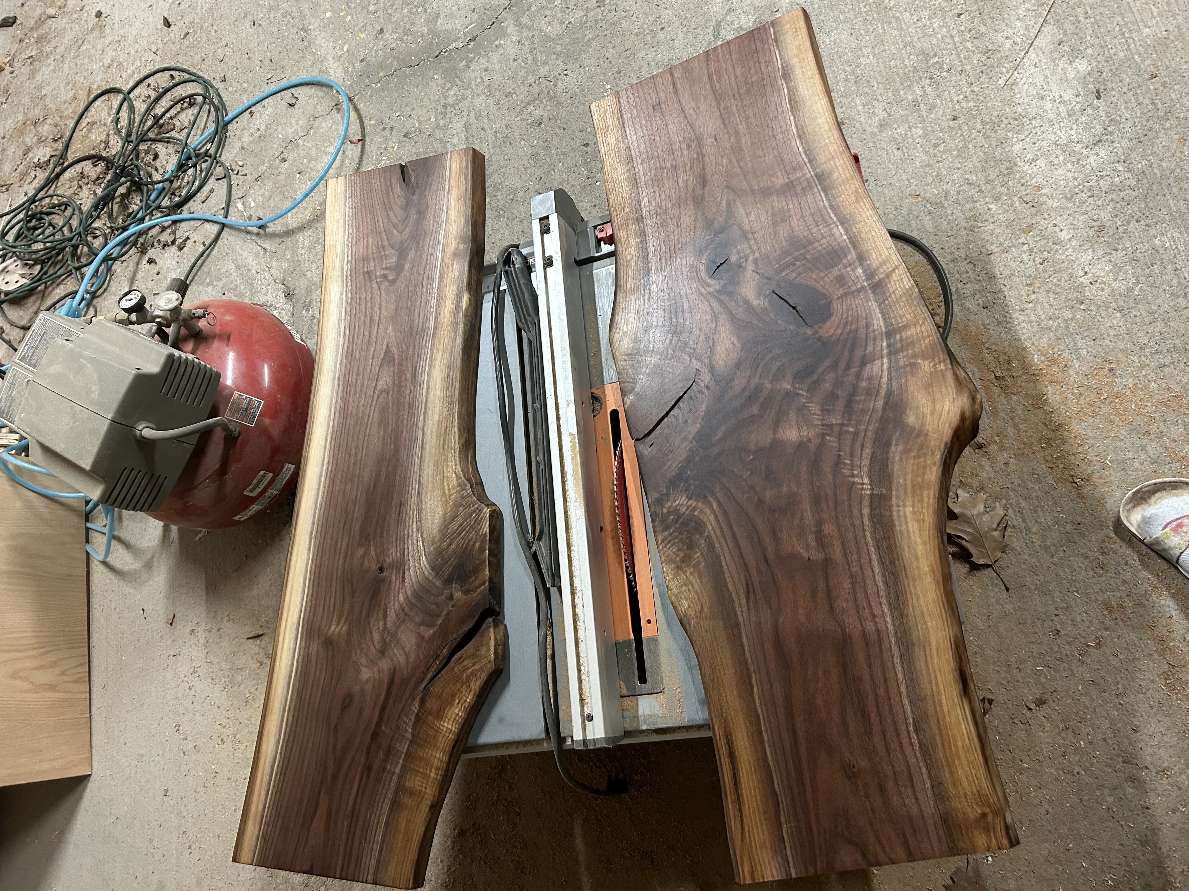Raw live-edge walnut slabs being prepared on planer - Ottawa Handiman custom charcuterie boards