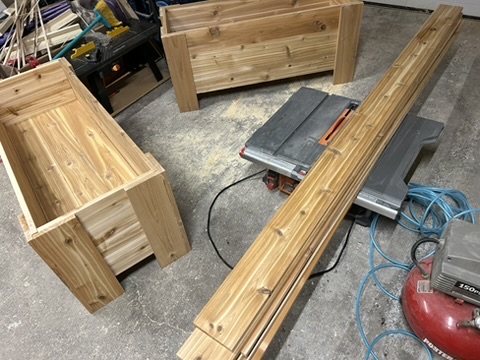 Multiple cedar planter boxes with fence lumber ready for assembly - Ottawa Handiman